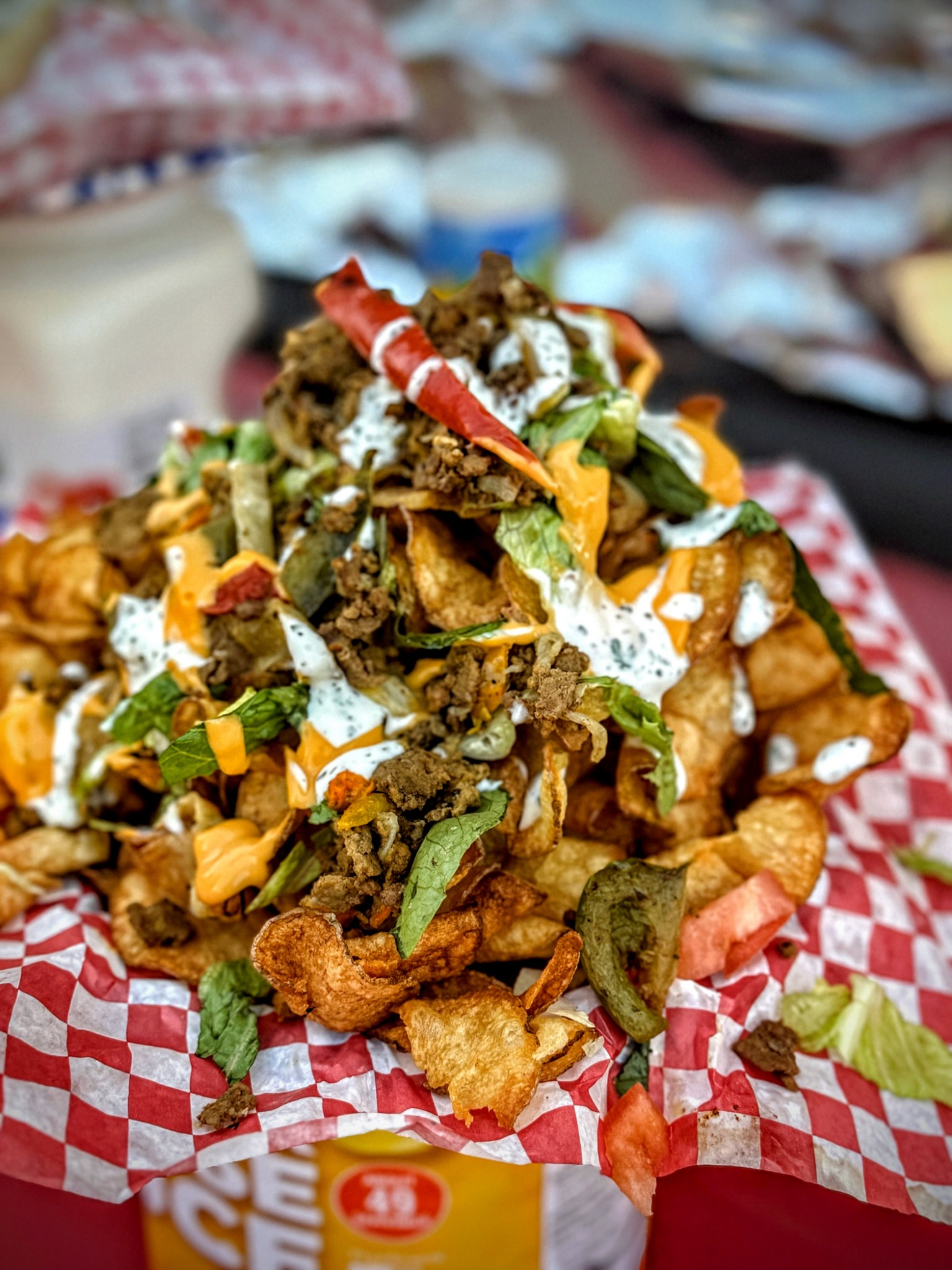 Loaded chips topped with meat, vegetables and sauces